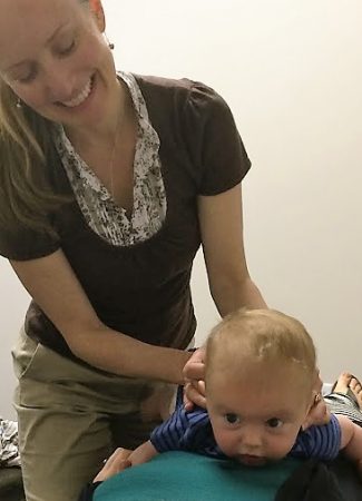 Frederick chiropractor checks baby's spine